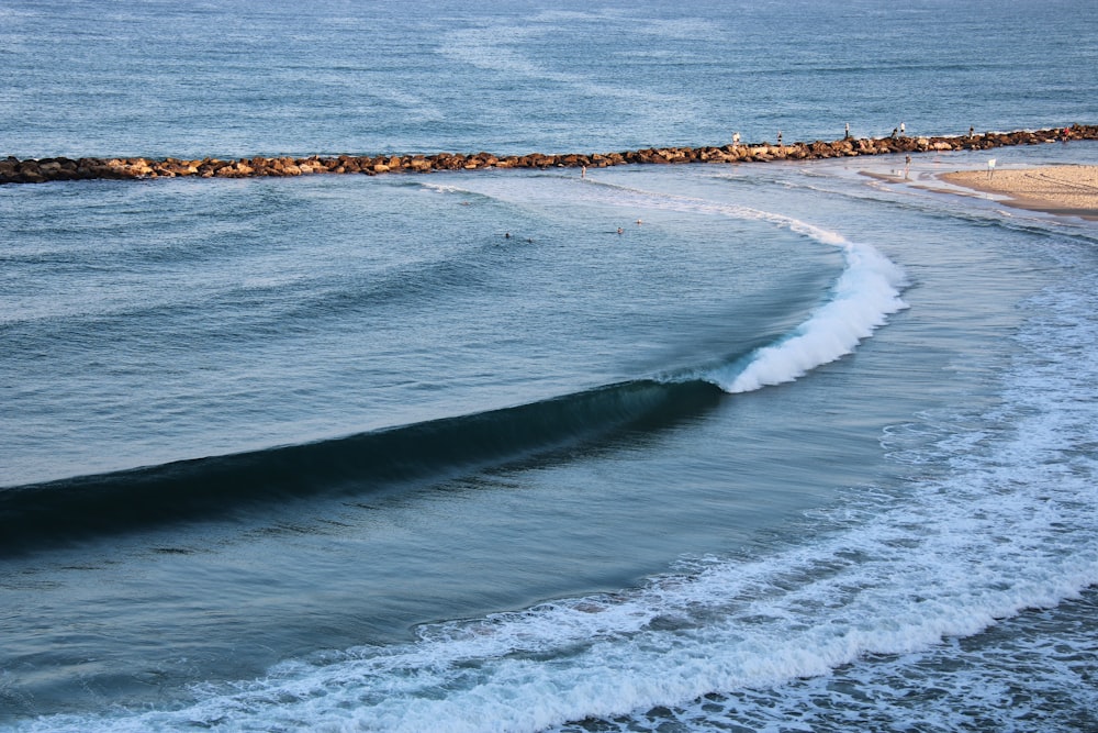 a person riding a surfboard on a wave in the ocean