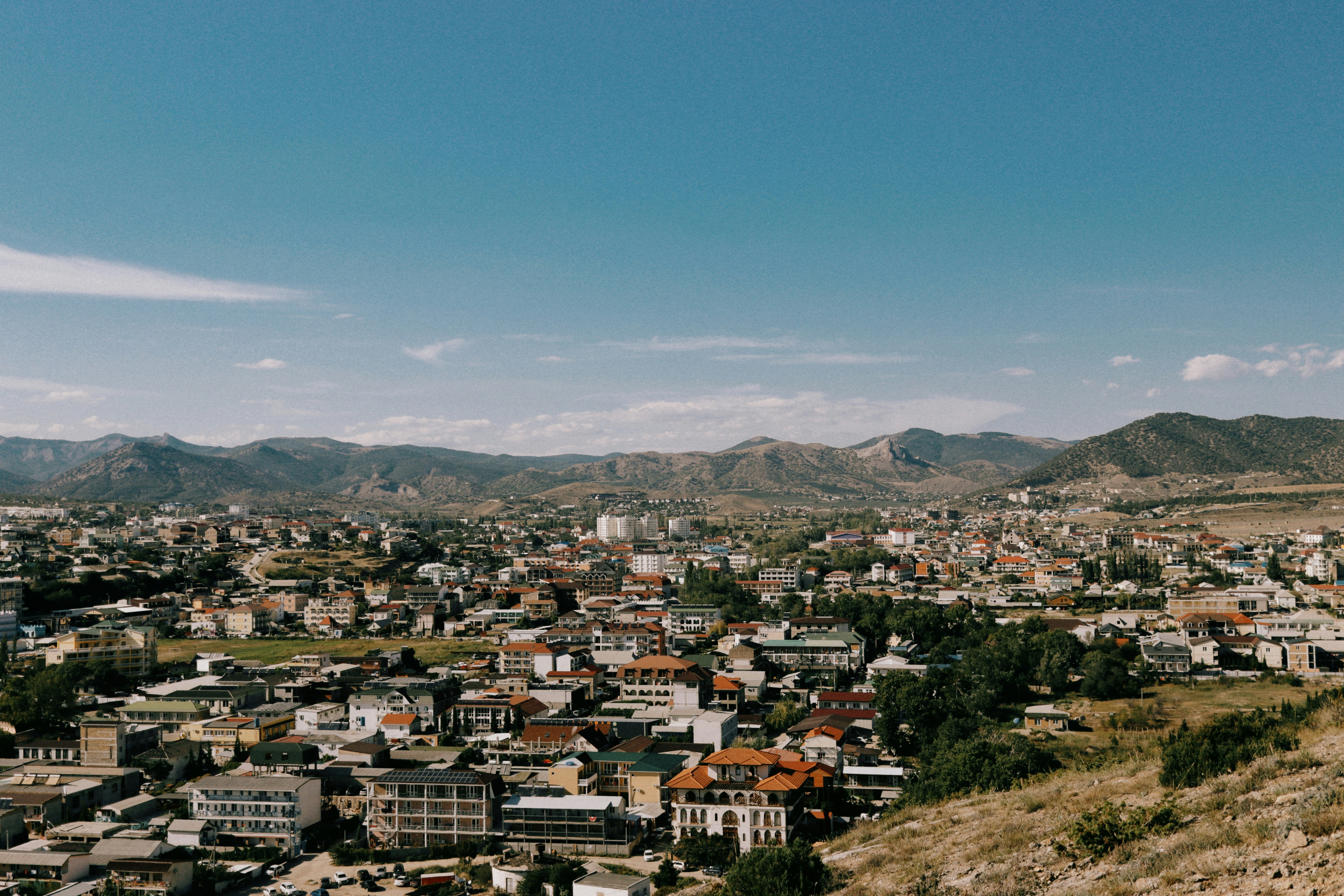 a view of a city with mountains in the background