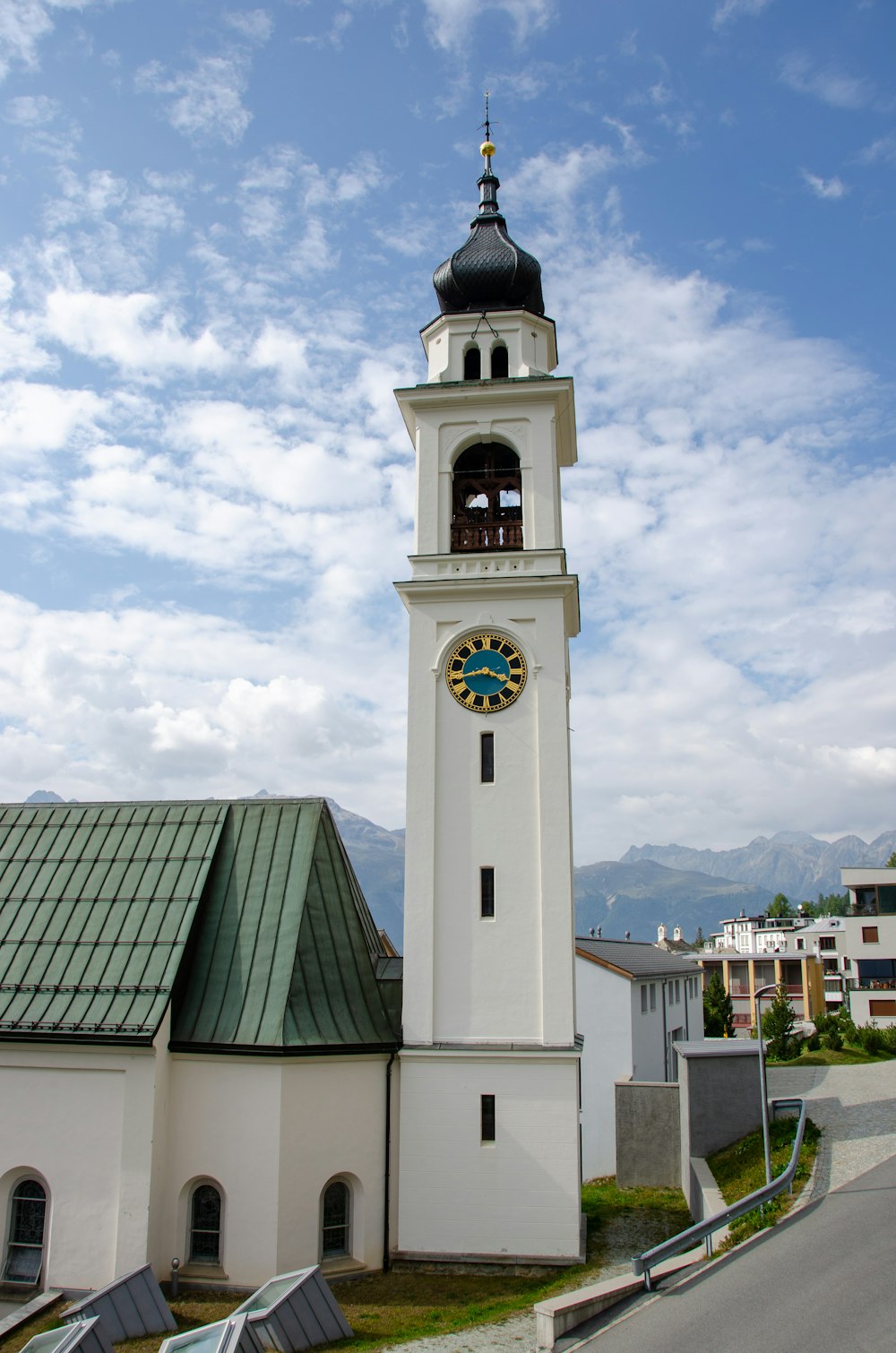 a large white clock tower with a sky background