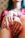 A close-up of hands gently pressing into a Chinese finger puzzle, symbolizing the process of release and self-discovery.