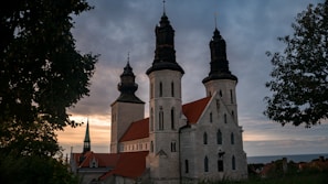Historic church in Oeiras silhouetted against a warm sunset sky