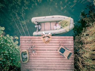 a boat is docked on a wooden dock