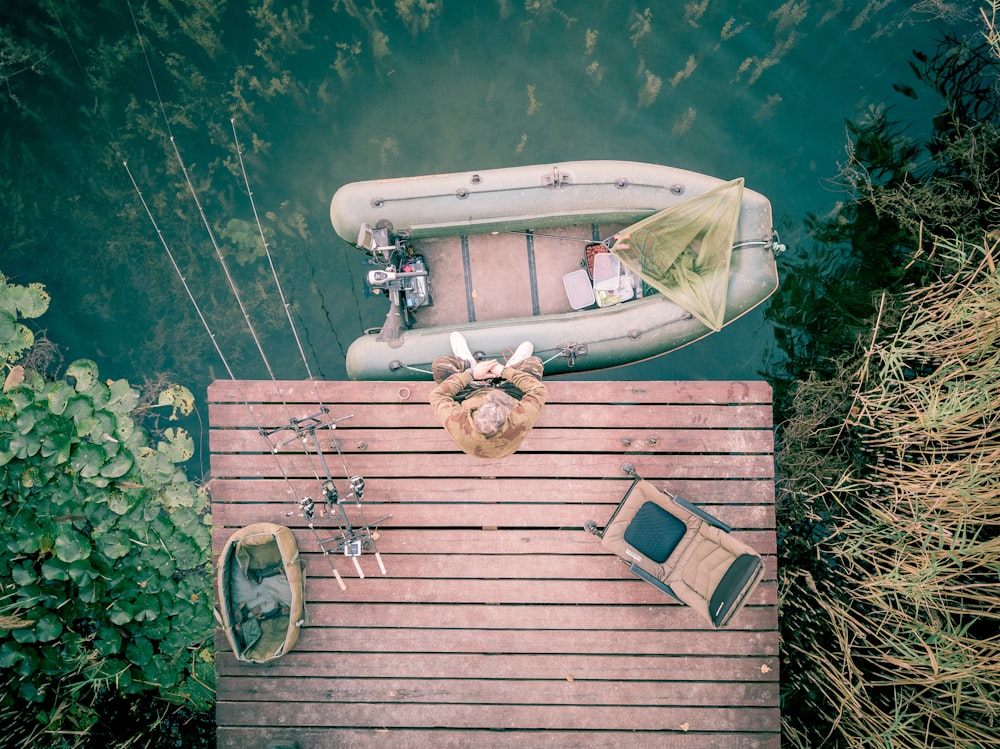 a boat is docked on a wooden dock