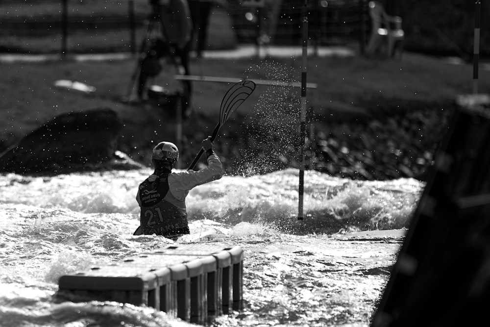 a person in a body of water holding a flag