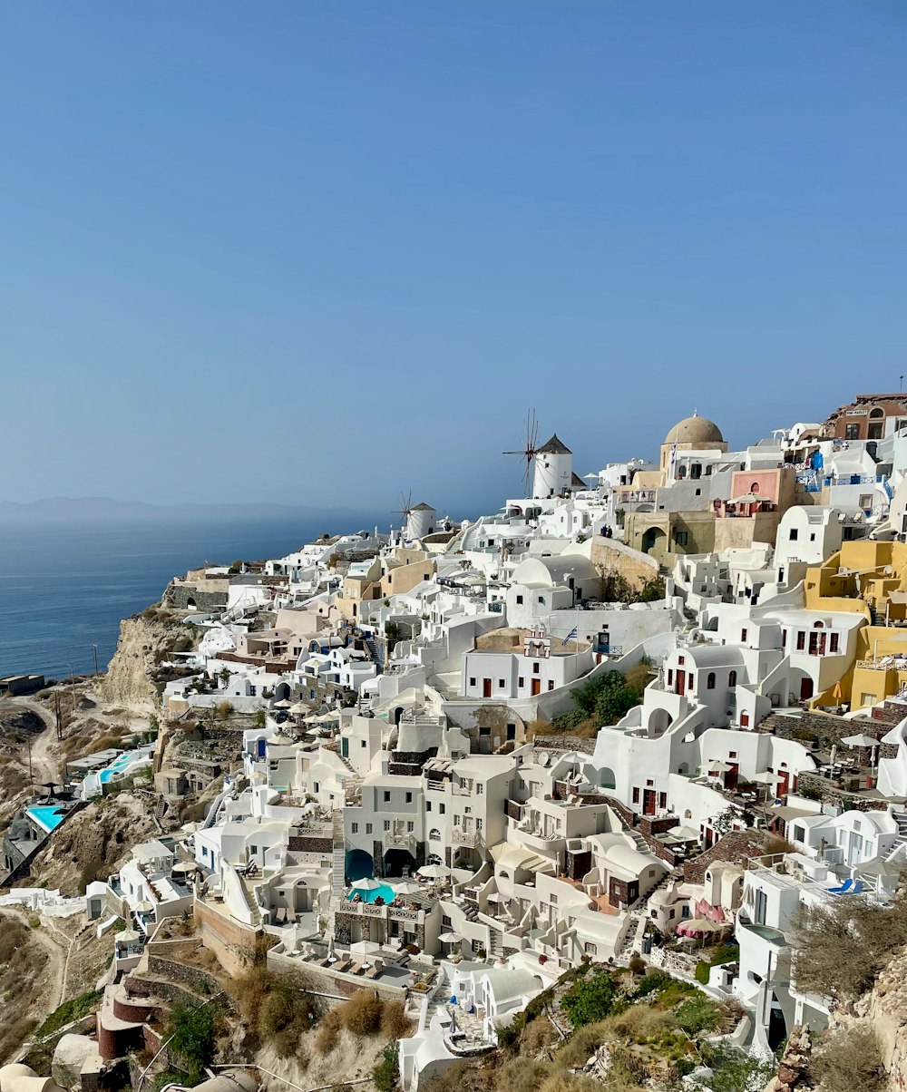 a view of a village on a cliff overlooking the ocean