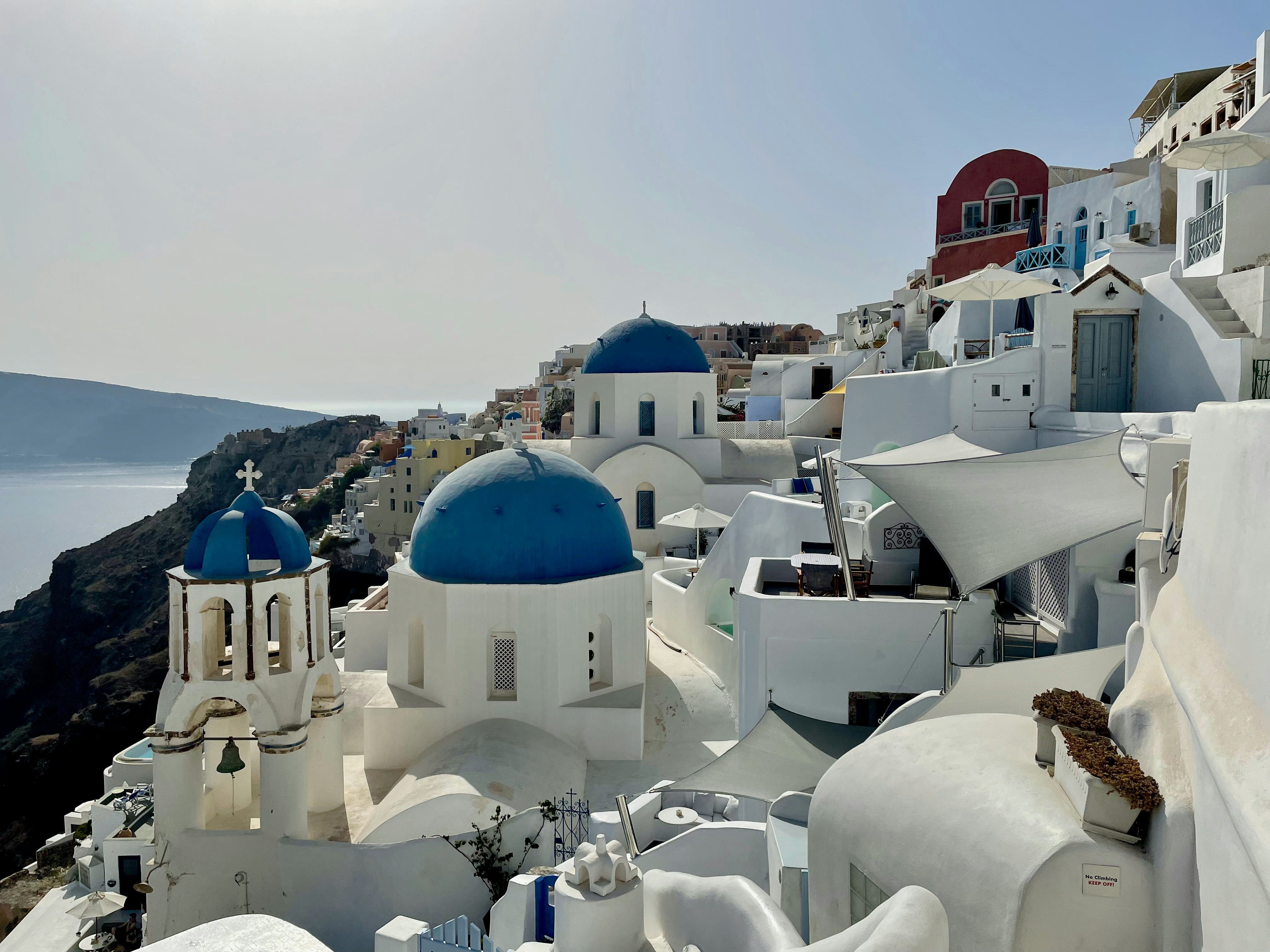A picturesque village in Santorini with blue-domed churches.