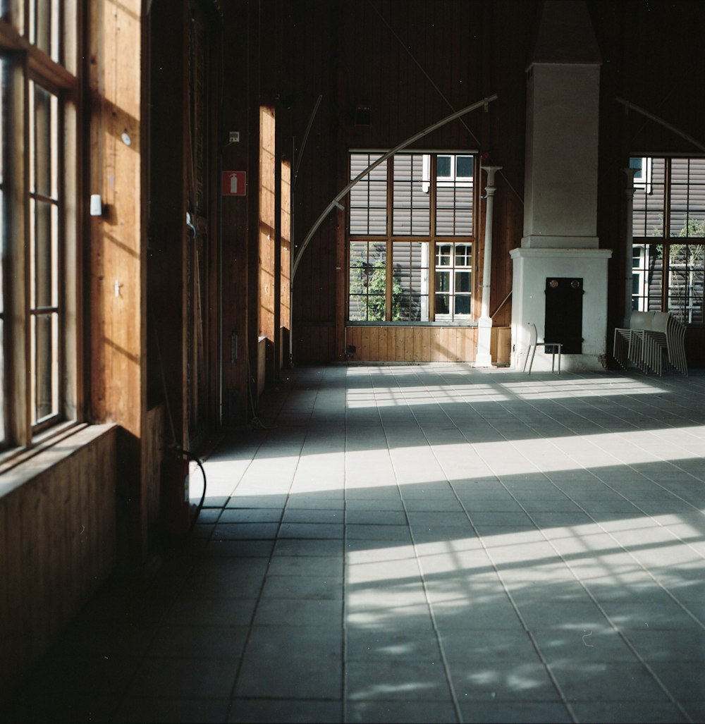 a large room with several windows and a clock on the wall