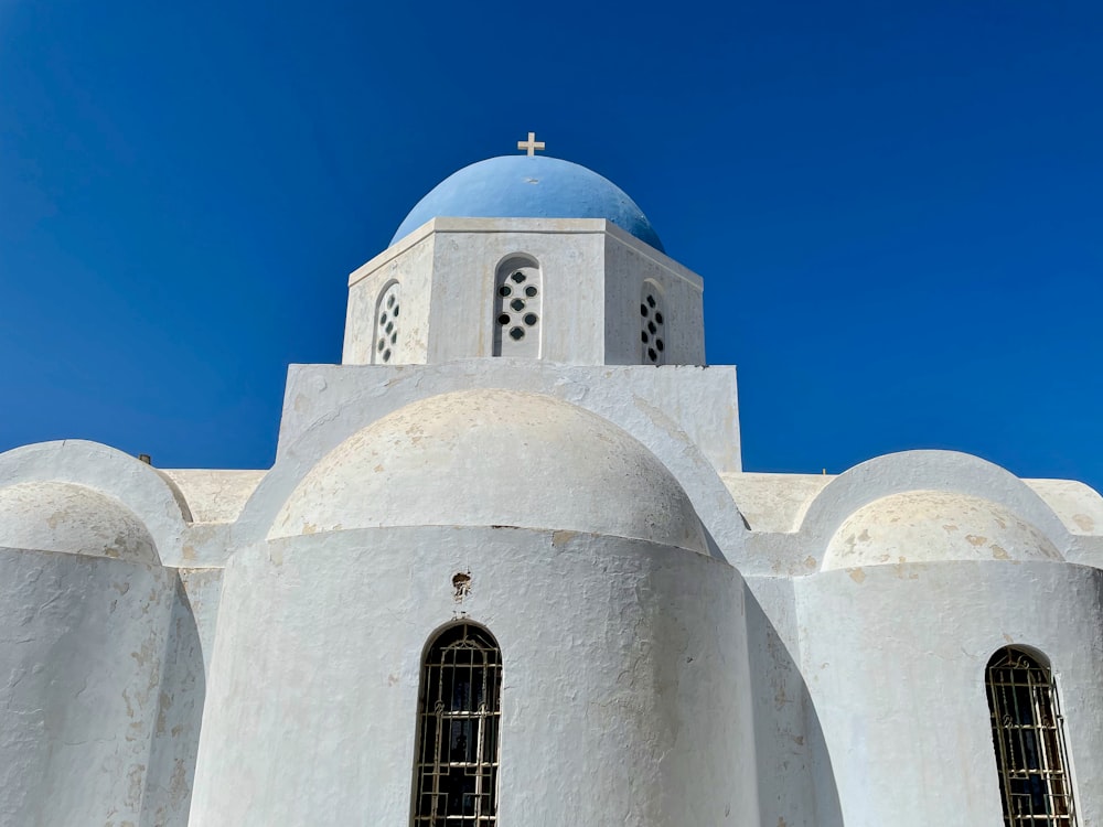 a white building with a blue dome on top