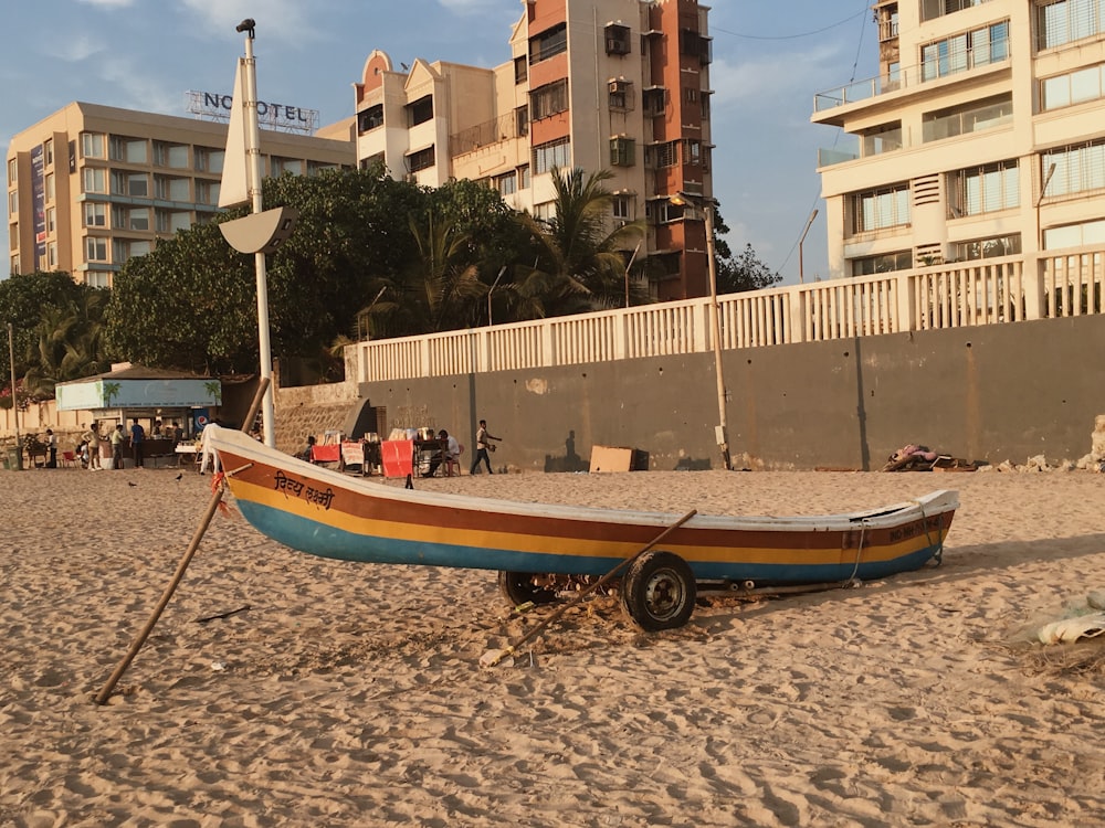 a boat sitting on top of a sandy beach