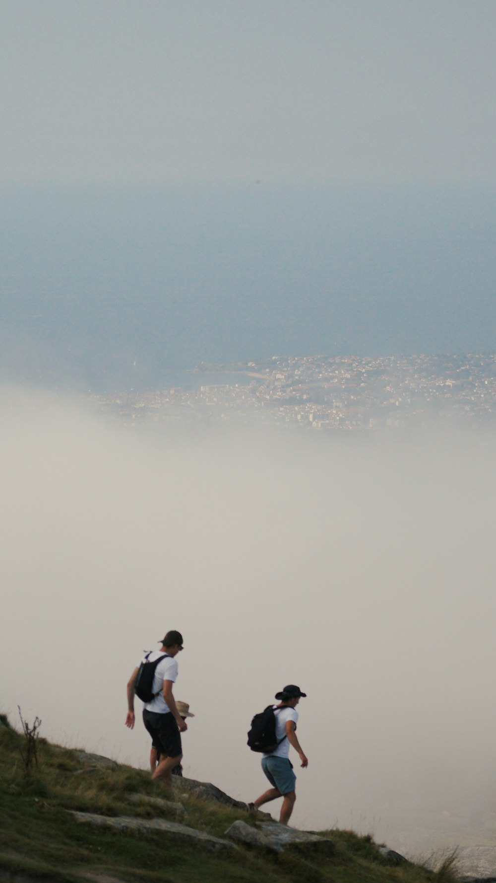 a couple of people that are walking up a hill