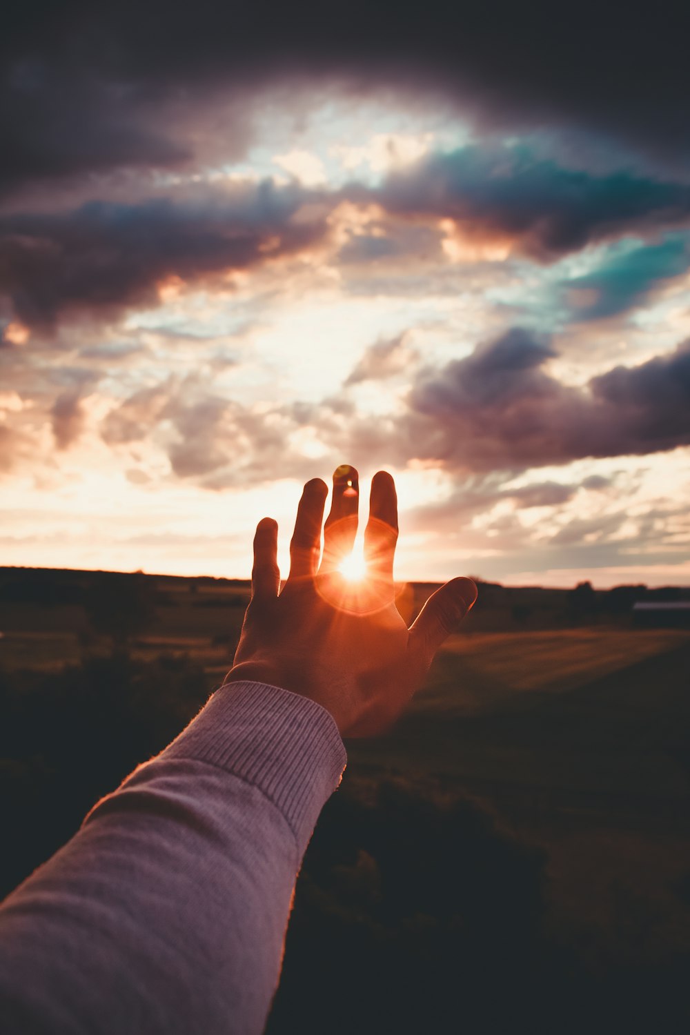 a person standing in front of a sunset