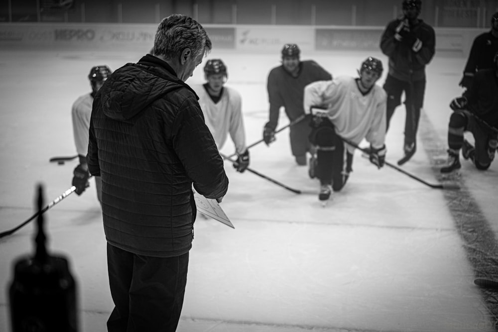 a group of men playing a game of ice hockey