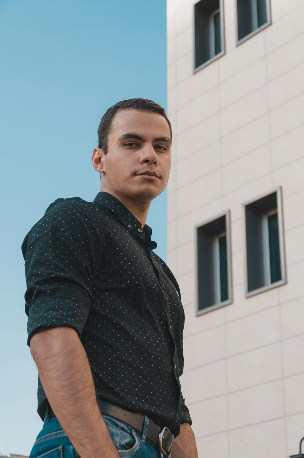 a man standing in front of a building