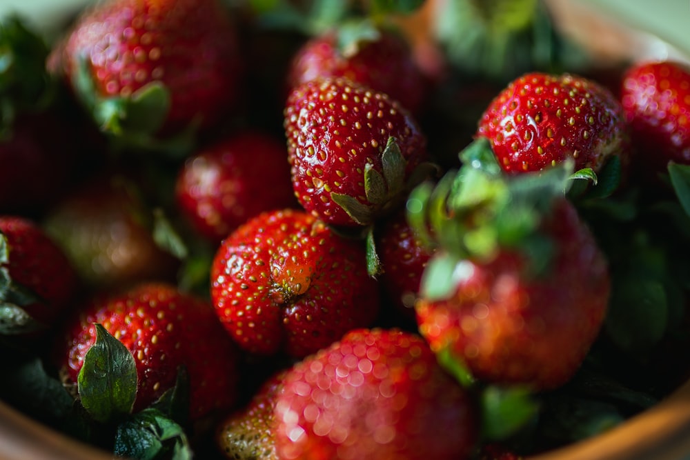 a close up of a bowl of strawberries