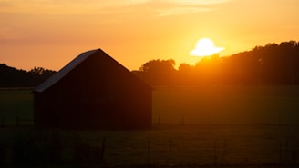 The silhouette of a barn against a colorful Georgia sunset in Paulding County.