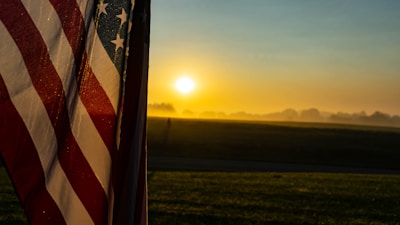 A sunrise over a peaceful American small town, evoking hope and freedom.