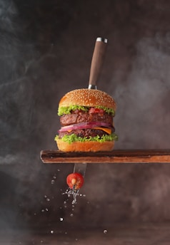 a hamburger with a knife sticking out of it