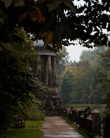 a stone monument in a park with trees in the background