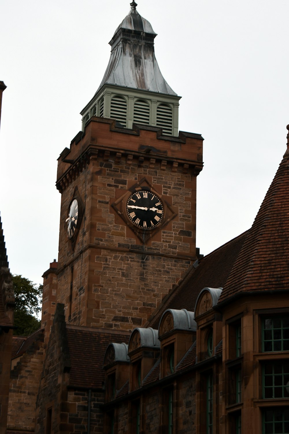 a clock tower with a weather vein on top of it