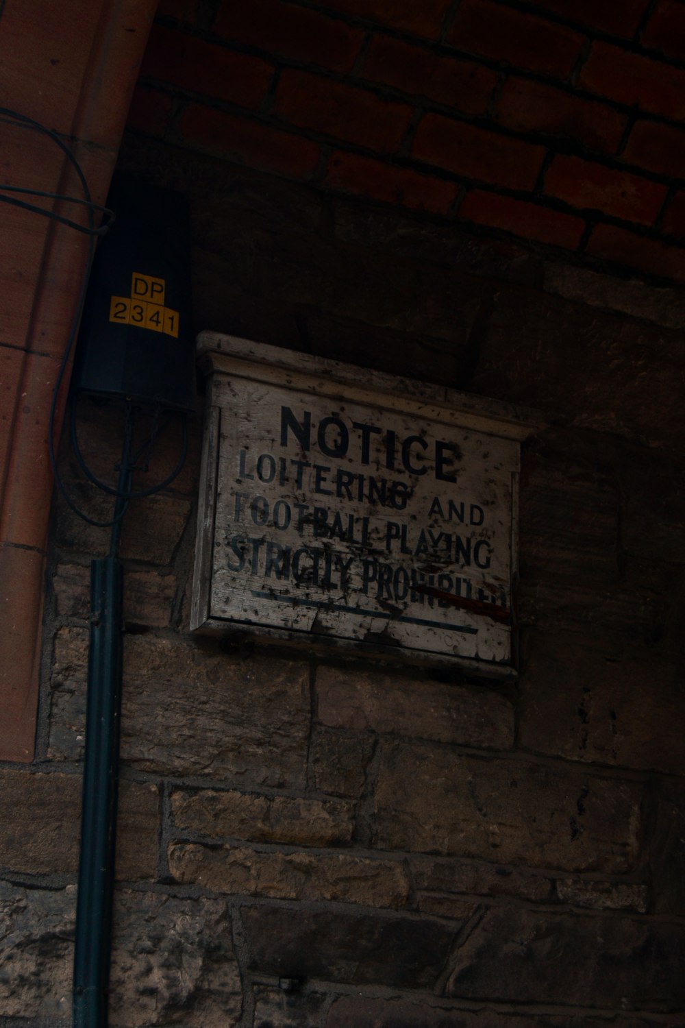 a sign on the side of a brick building