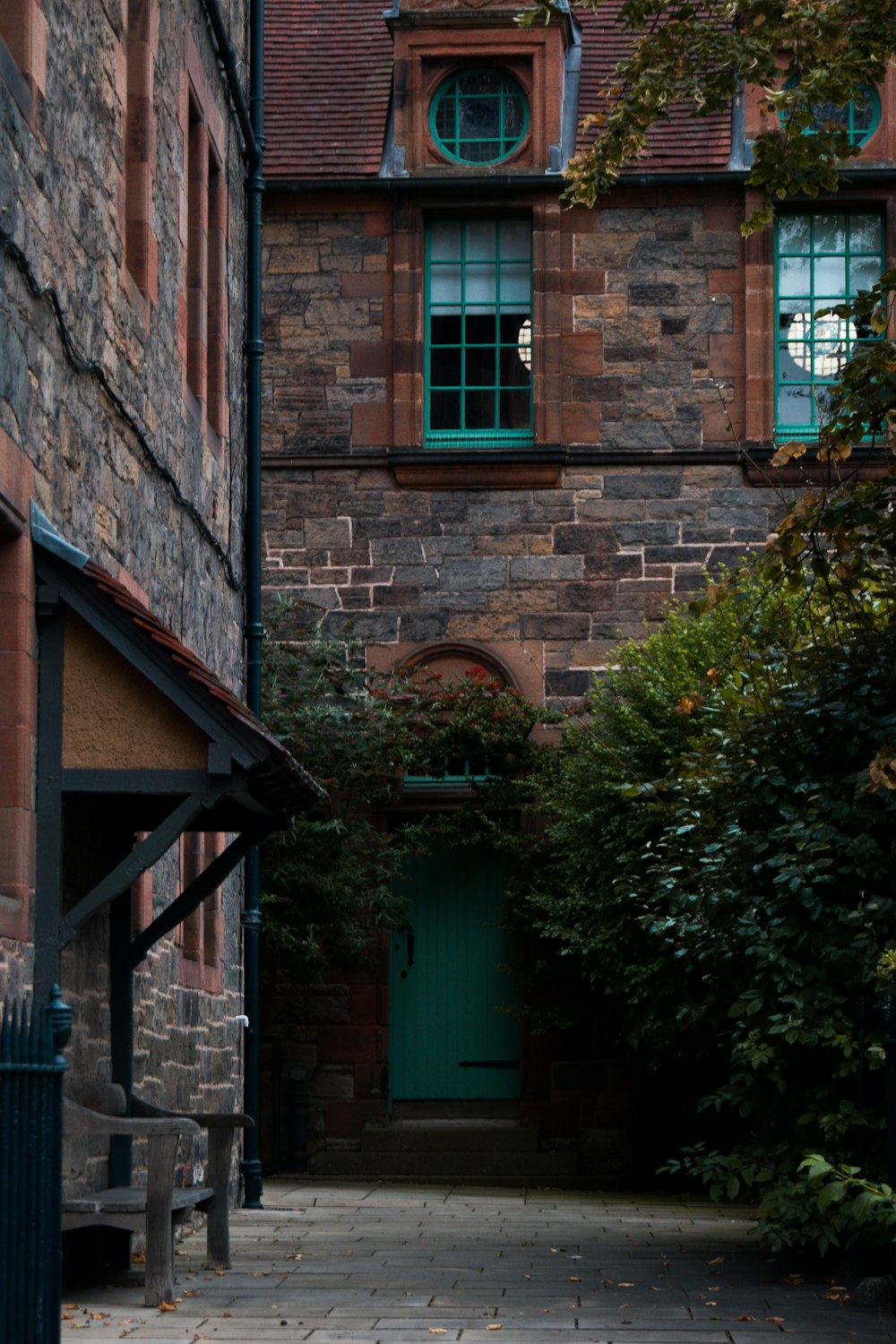 a brick building with a green door and window