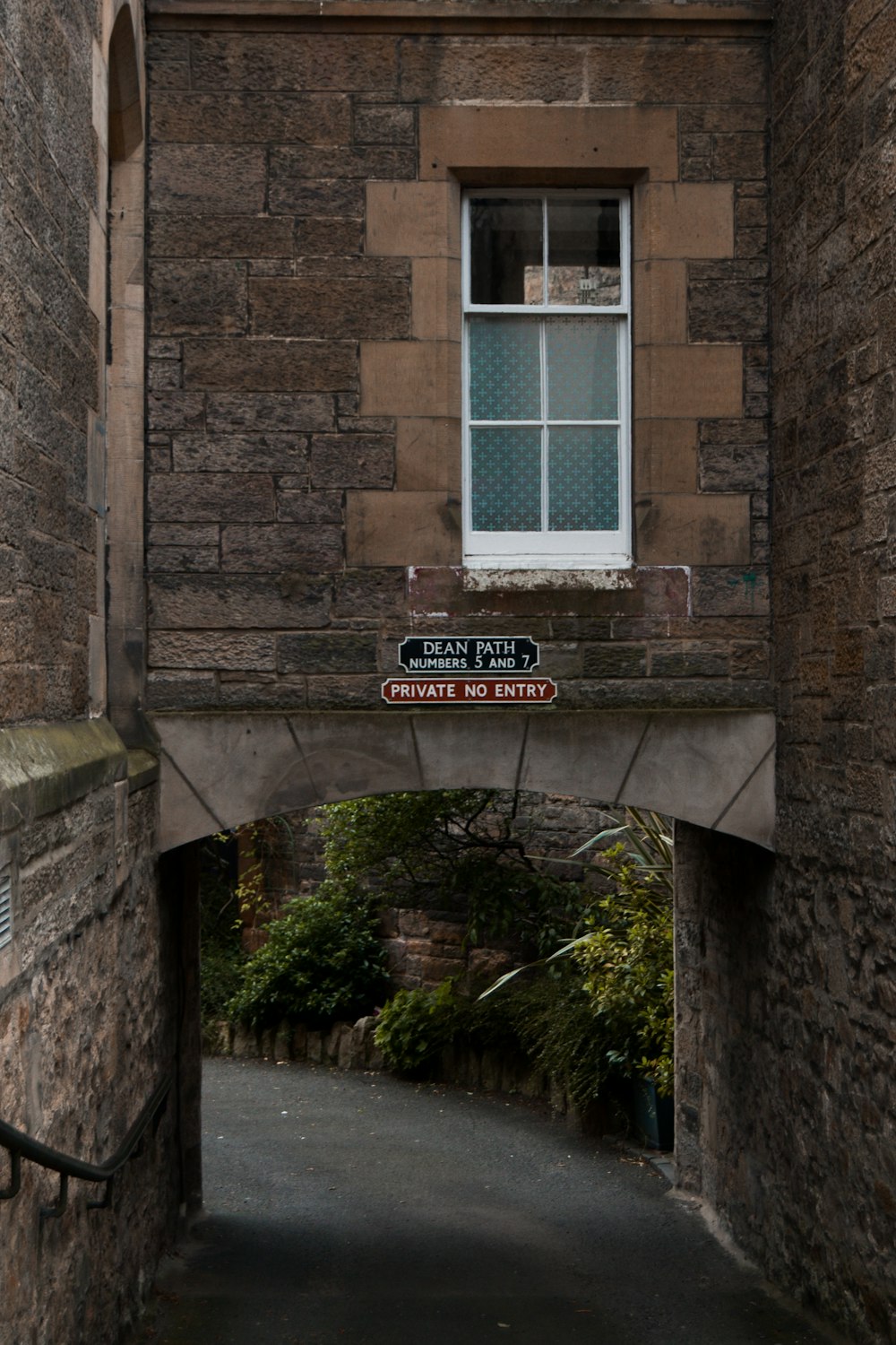 a stone building with a street sign in front of it