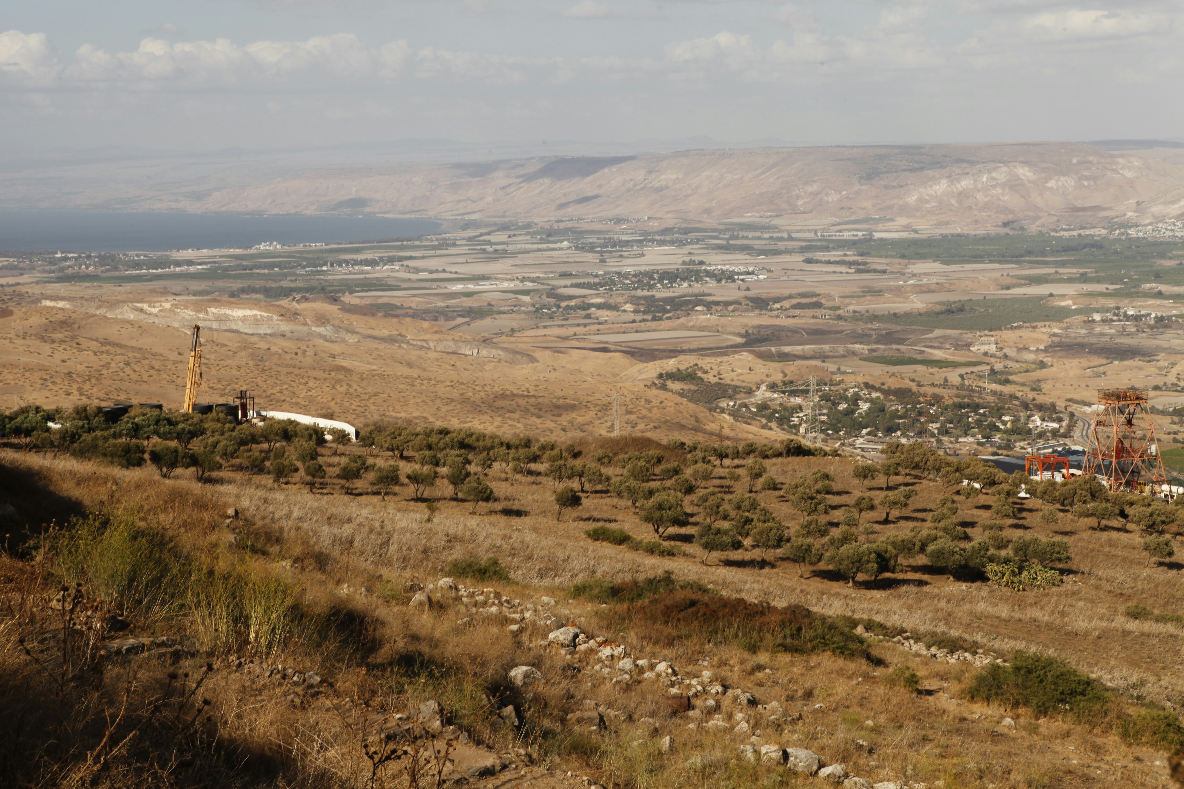 a view of a valley with a windmill in the distance