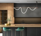 a modern kitchen with a bar and stools