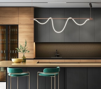 a modern kitchen with a bar and stools