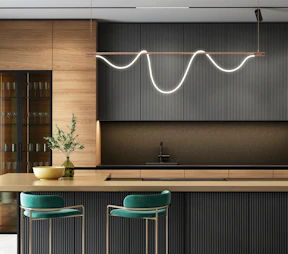 a modern kitchen with a bar and stools