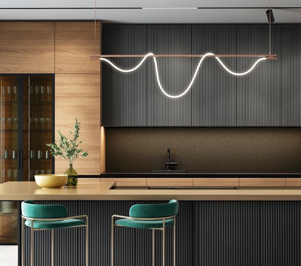 a modern kitchen with a bar and stools