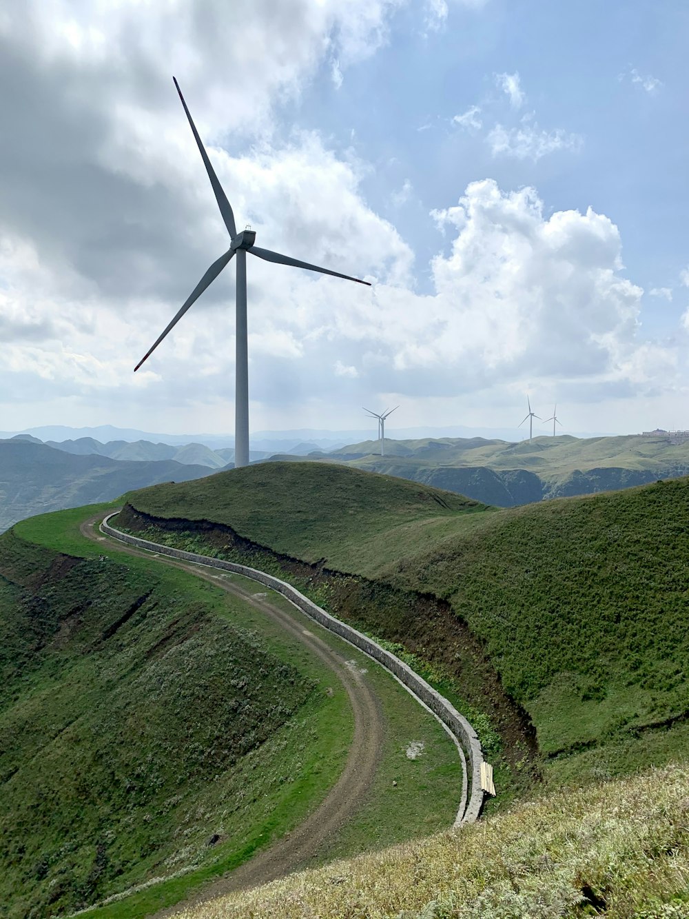 a wind turbine on top of a hill