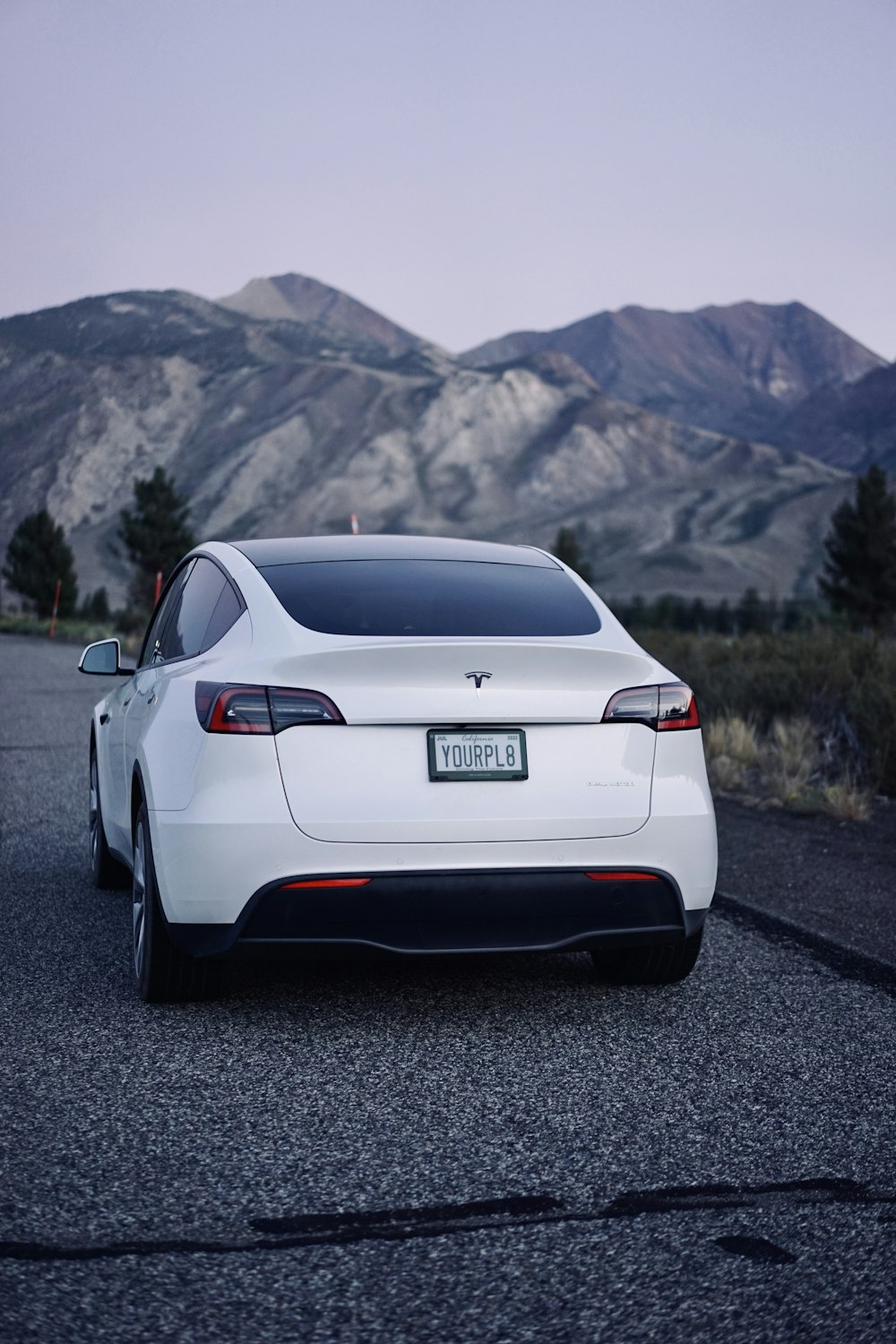 a white car parked on the side of a road