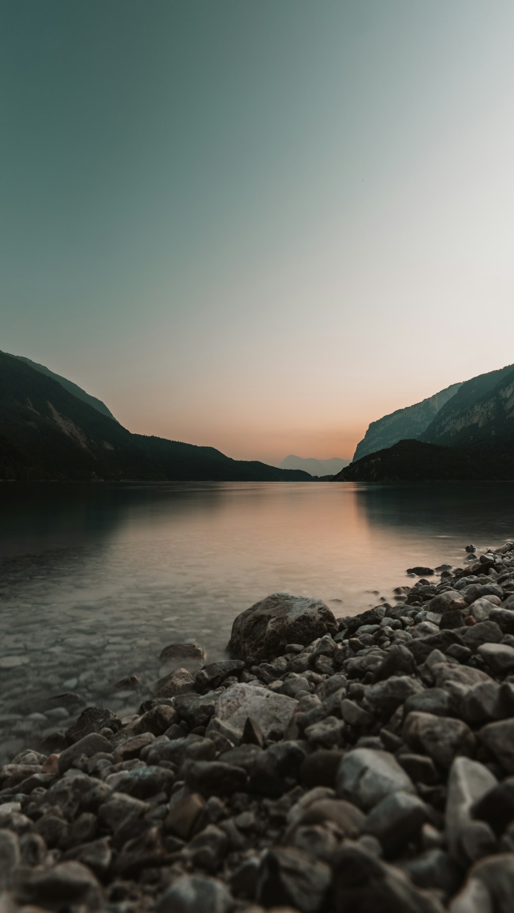 a body of water surrounded by mountains and rocks