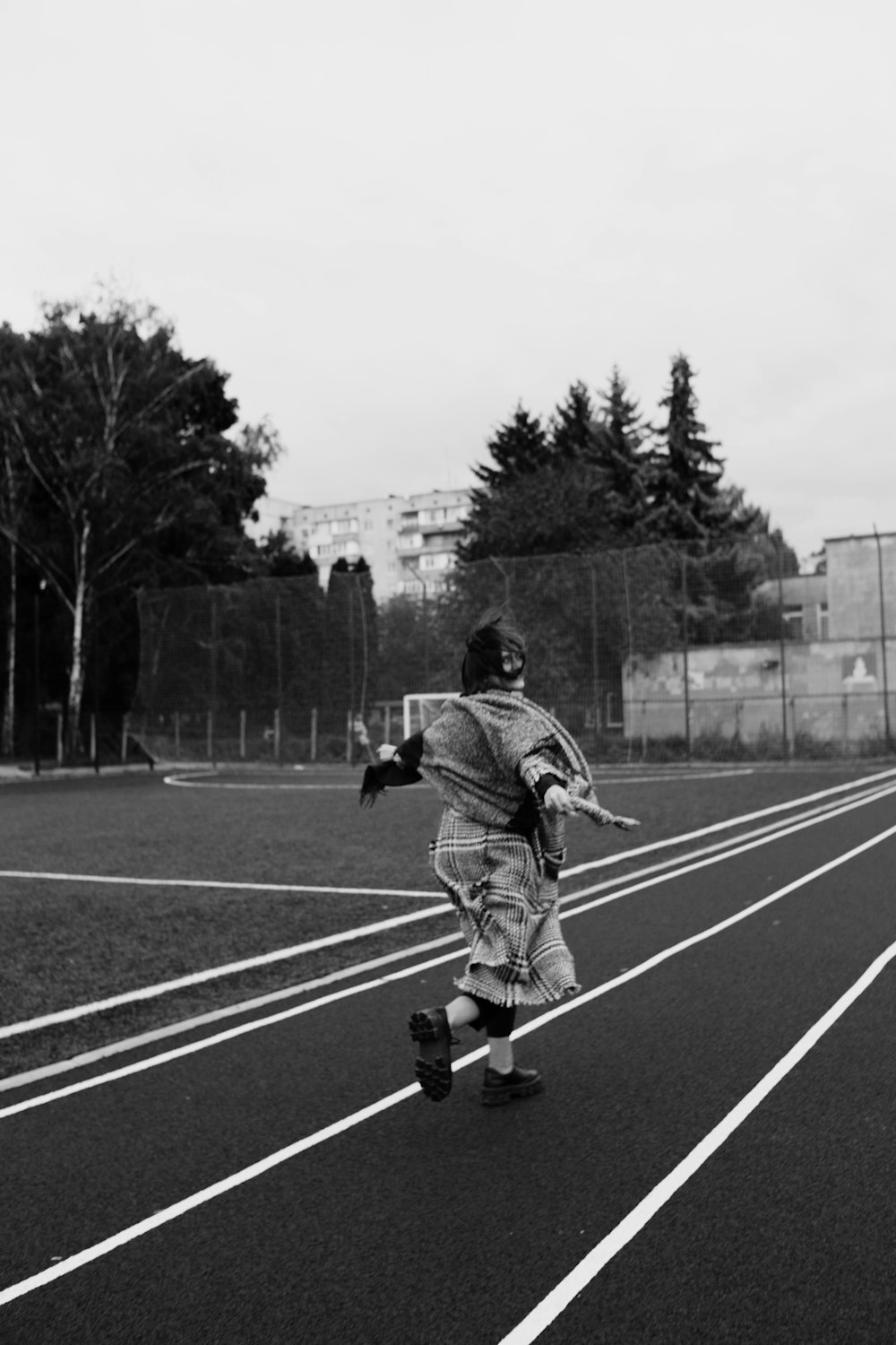 a person running on a track in a field
