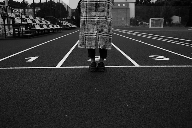 a person standing in the middle of a parking lot