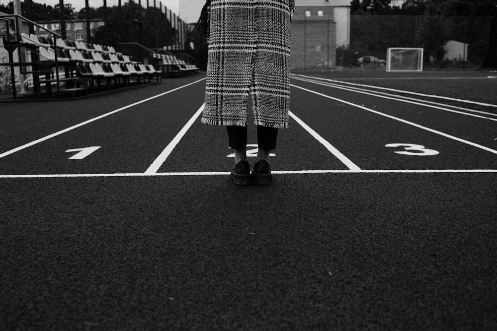 a person standing in the middle of a parking lot