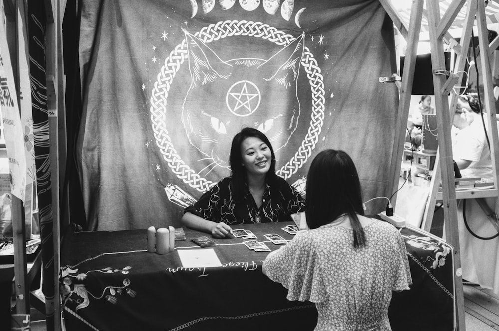 a couple of women sitting at a table