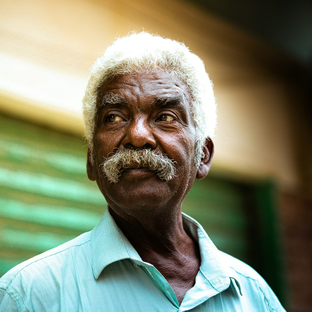 a man with a white beard and a blue shirt