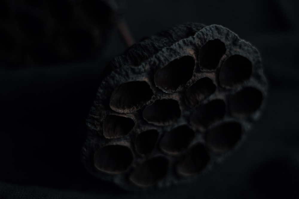 a close up of a black object with holes in it