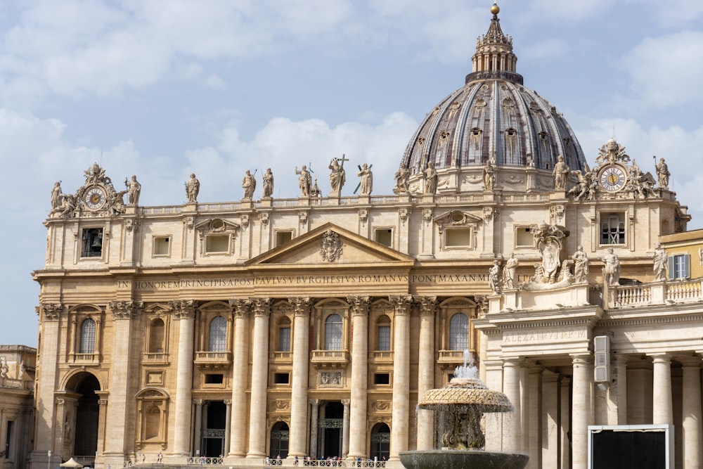 a large building with a fountain in front of it