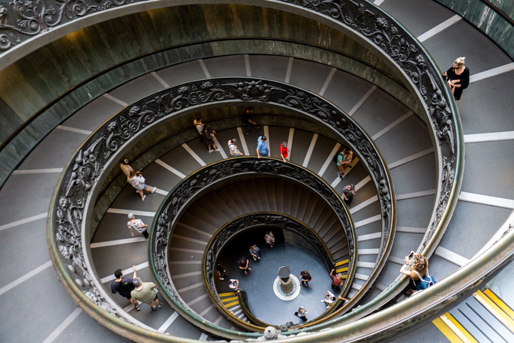 a group of people standing in the middle of a spiral staircase