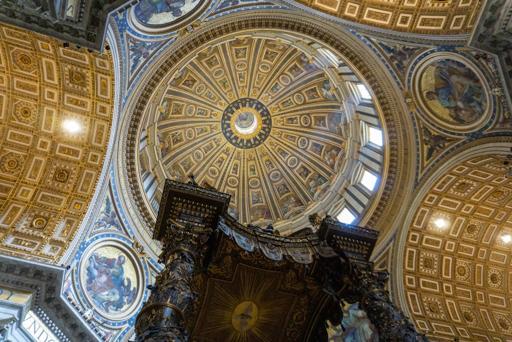 the ceiling of a church with a dome and paintings on it