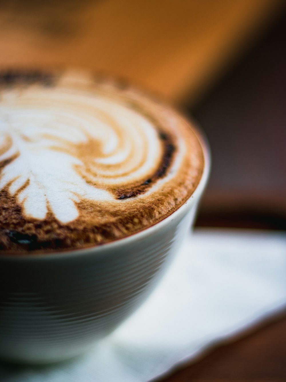 a cappuccino with a leaf drawn on it