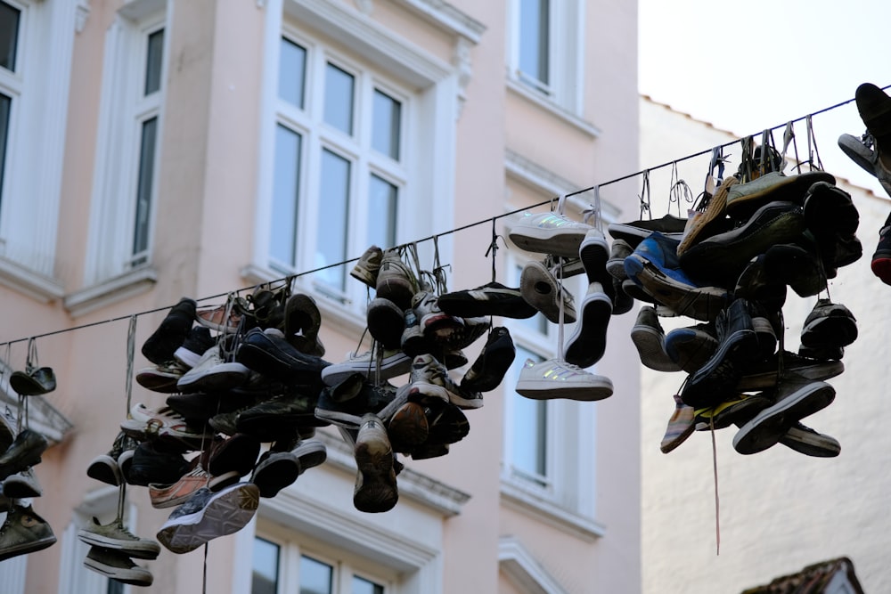 a bunch of shoes hanging on a clothes line