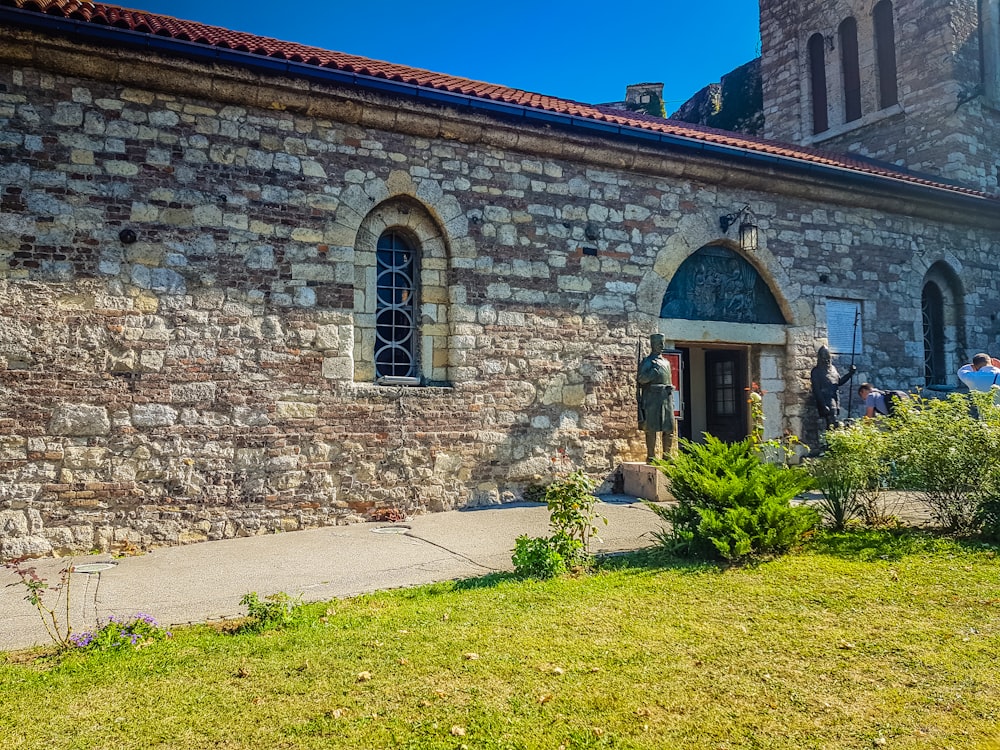 a stone building with a clock tower in the background