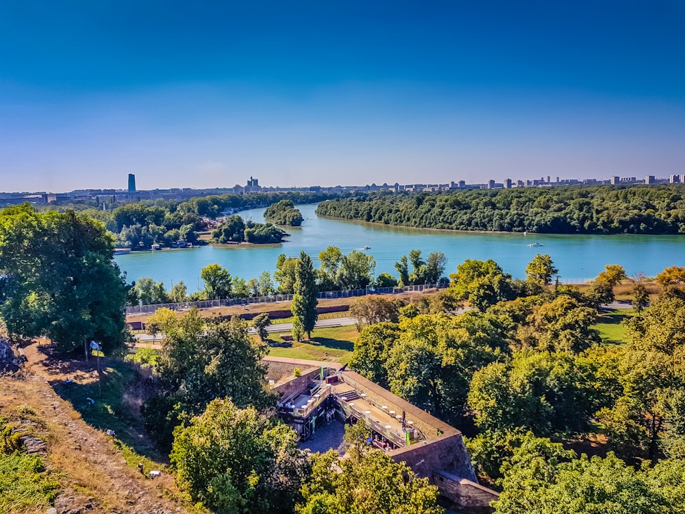 an aerial view of a river running through a park