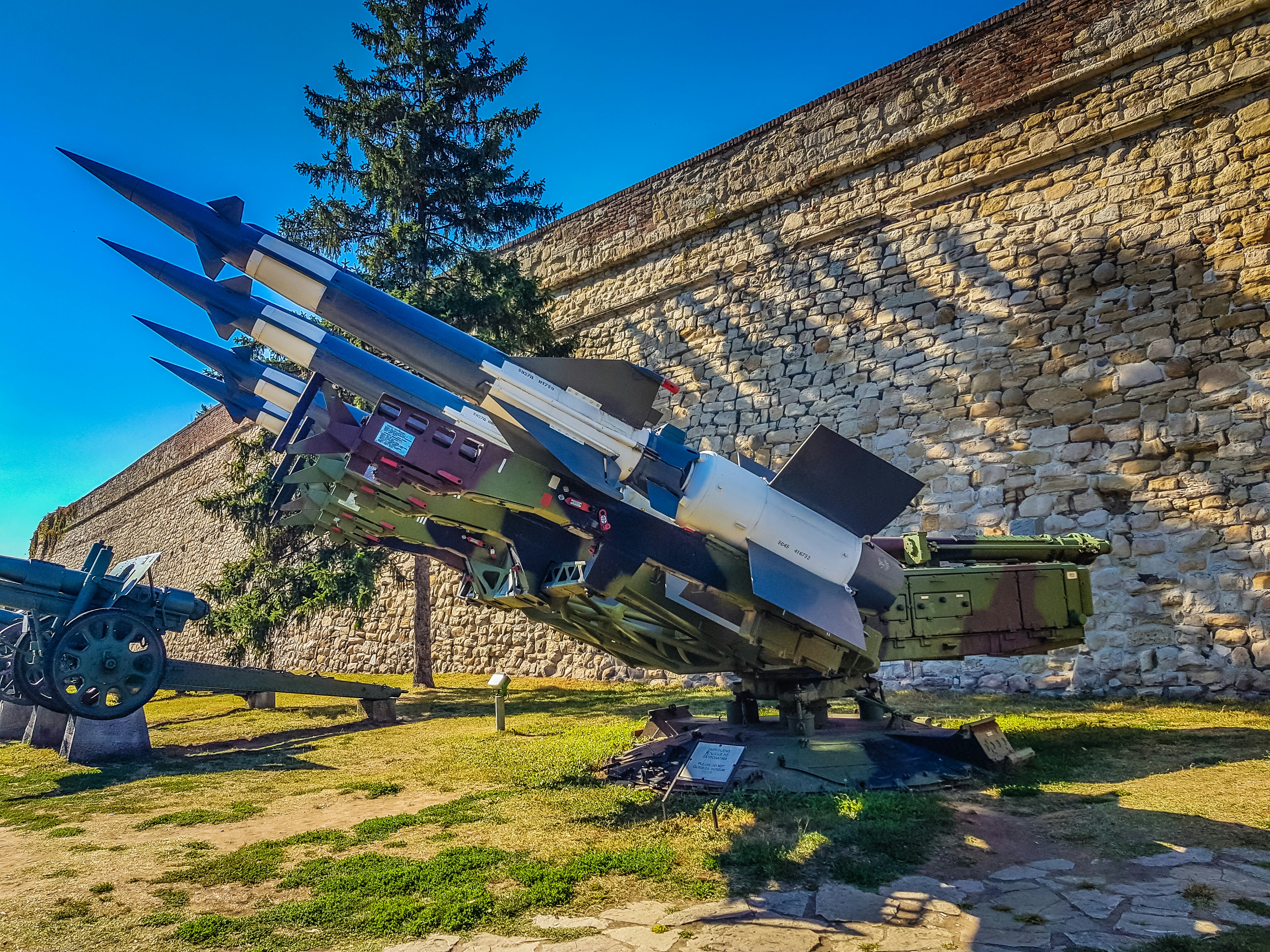 a large metal object sitting on top of a grass covered field