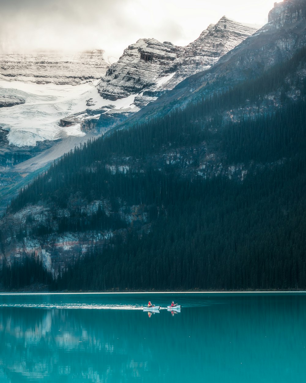 a couple of boats floating on top of a lake