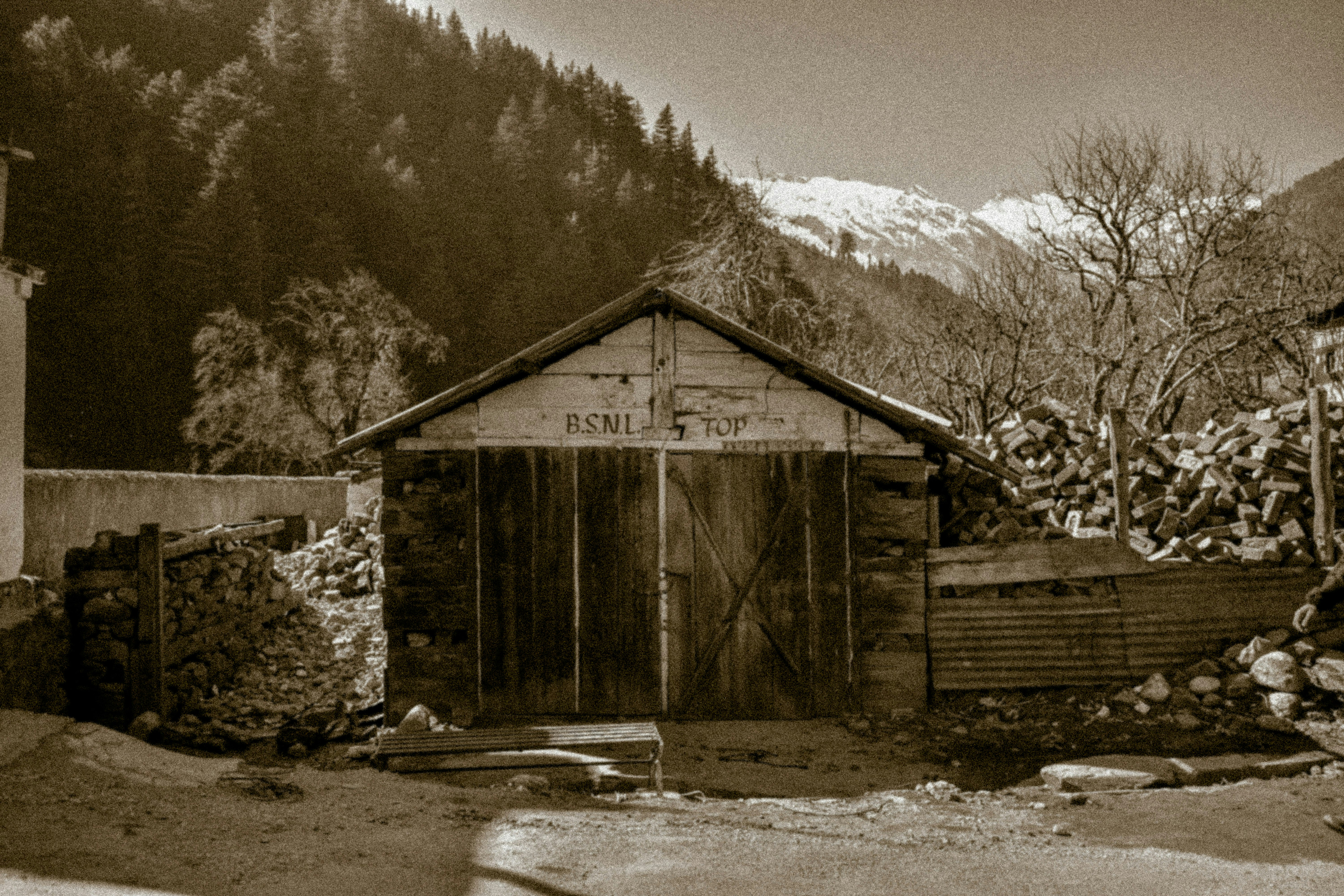 a black and white photo of a wooden shed